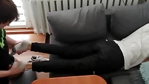 Young beggar pays out his bills with his feet